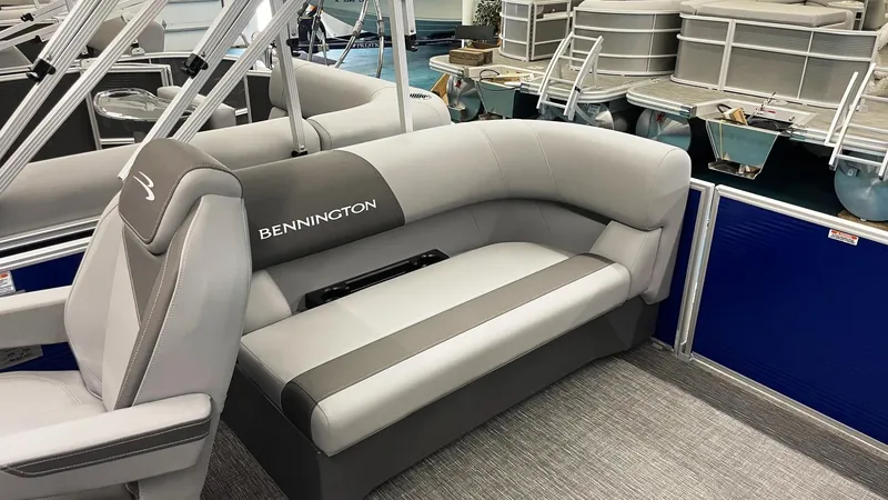 Slide: The Image of 2024 Bennington 20 SVSR pontoon boat with gray seating and blue paneling. - 4