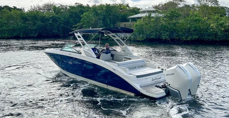 Slide: The Image of 2023 Sea Ray SDX 290 Outboard boat cruising on a river. - 1