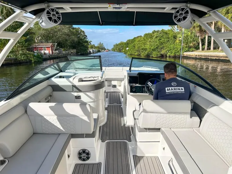 Slide: The Image of 2023 Sea Ray SDX 290 Outboard boat cruising on a scenic waterway. - 14
