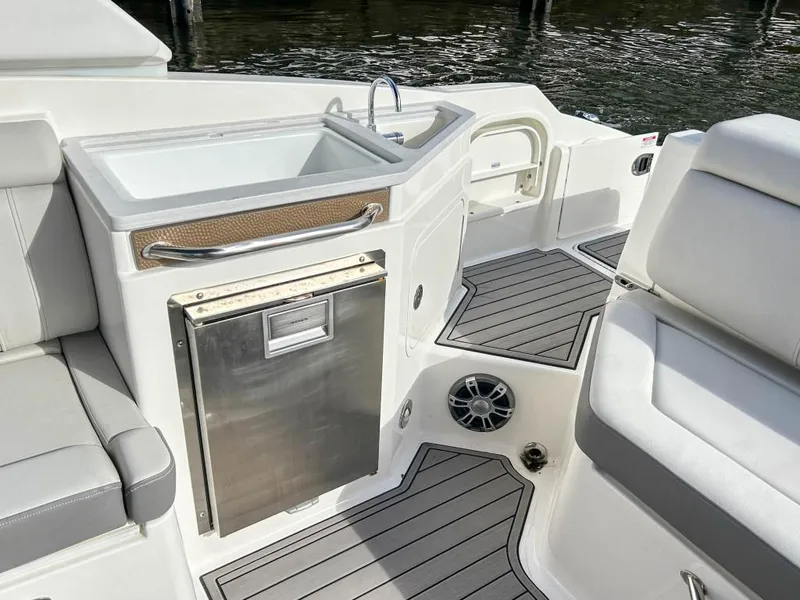 Slide: The Image of 2023 Sea Ray SDX 290 Outboard boat interior with sink and seating. - 17
