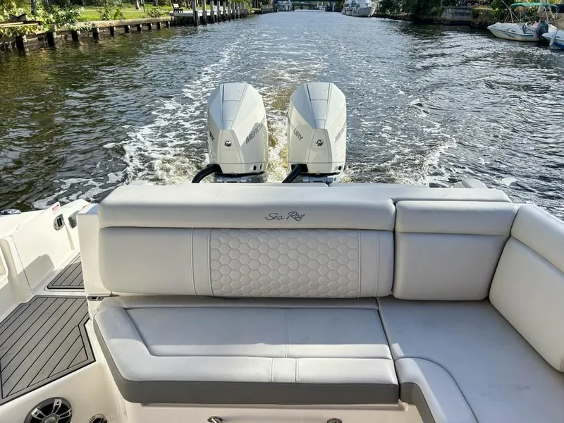 Slide: The Image of 2023 Sea Ray SDX 290 Outboard cruising on a river, view from the rear seating area. - 18