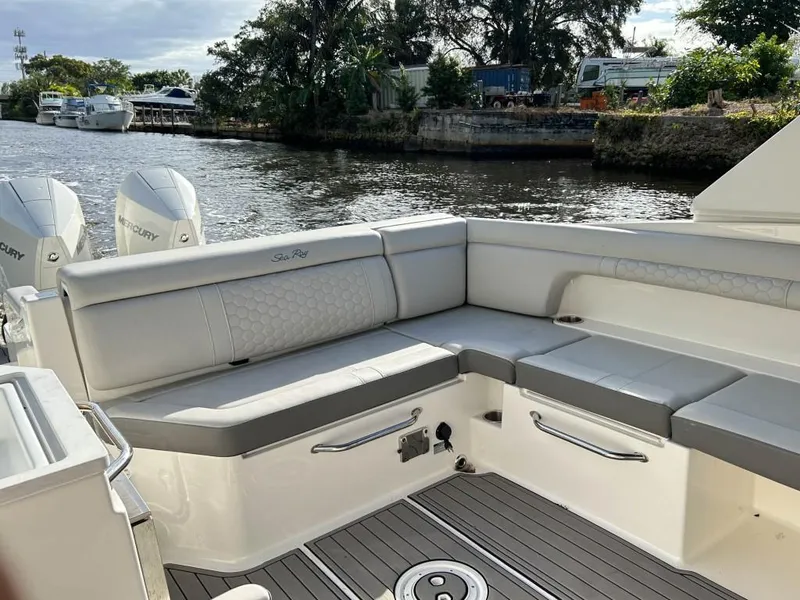 Slide: The Image of 2023 Sea Ray SDX 290 Outboard boat with spacious seating on a calm river. - 19