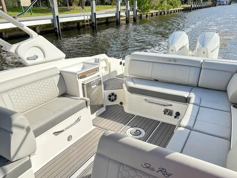 Slide: The Image of 2023 Sea Ray SDX 290 Outboard boat interior with luxurious seating and modern amenities. - 20
