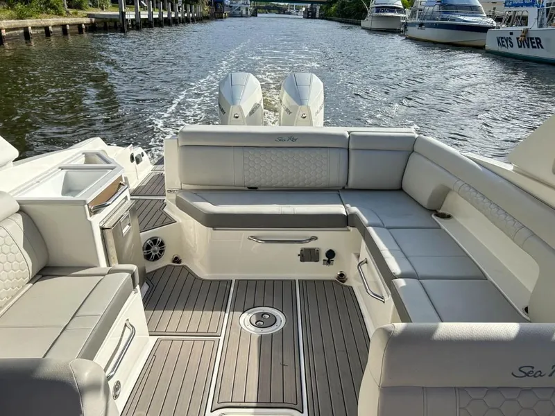 Slide: The Image of 2023 Sea Ray SDX 290 Outboard boat interior with spacious seating and twin engines. - 21
