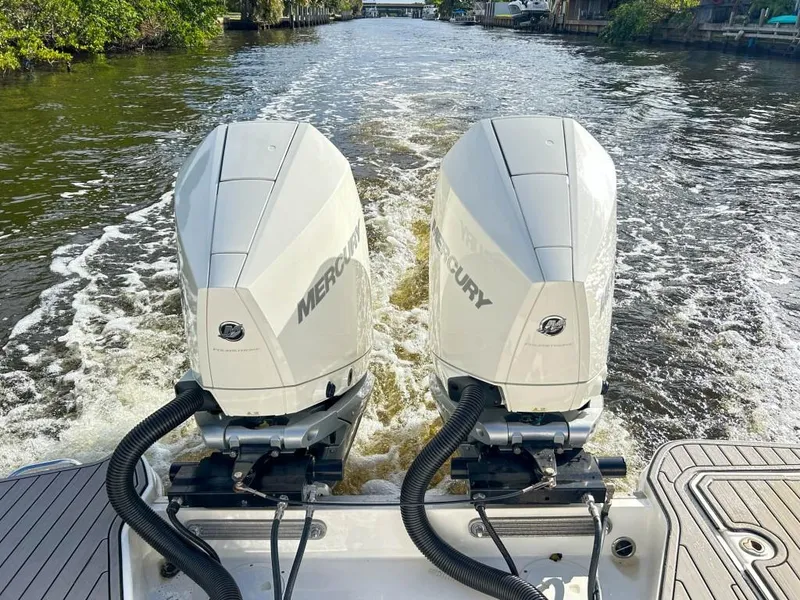 Slide: The Image of 2023 Sea Ray SDX 290 Outboard with twin Mercury engines on a river. - 22