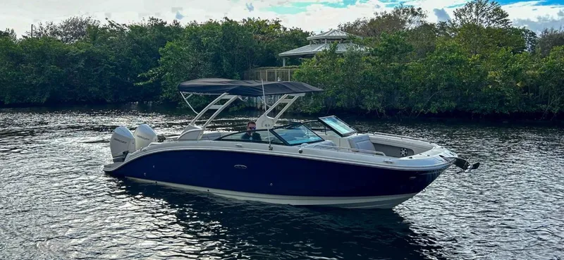Slide: The Image of 2023 Sea Ray SDX 290 Outboard boat cruising on a calm river. - 3