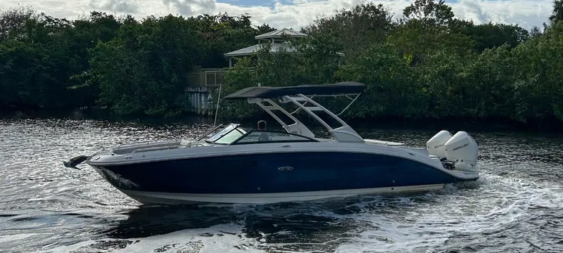 Slide: The Image of 2023 Sea Ray SDX 290 Outboard boat cruising on a river. - 6