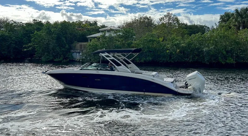 Slide: The Image of 2023 Sea Ray SDX 290 Outboard boat cruising on a scenic waterway. - 7