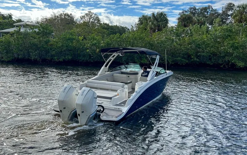 Slide: The Image of 2023 Sea Ray SDX 290 Outboard cruising on a scenic waterway. - 8