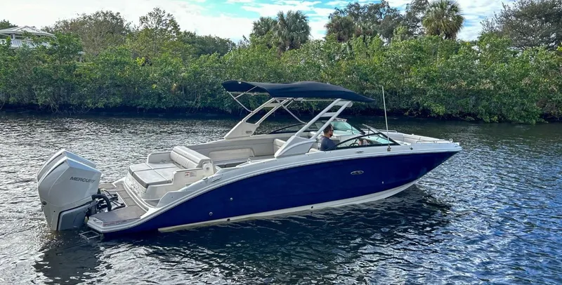 Slide: The Image of 2023 Sea Ray SDX 290 Outboard boat cruising on a scenic river. - 9