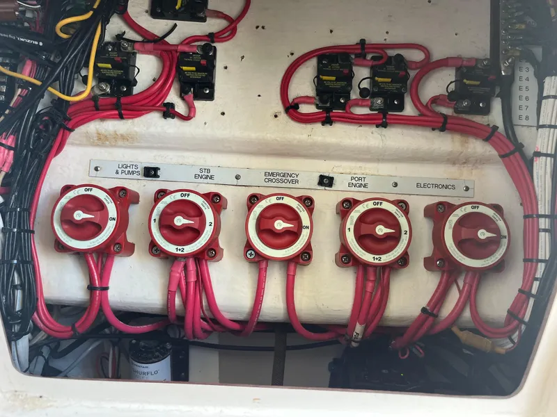 Slide: The Image of 2004 Venture 34 Center Console electrical panel with red wiring and switches. - 11