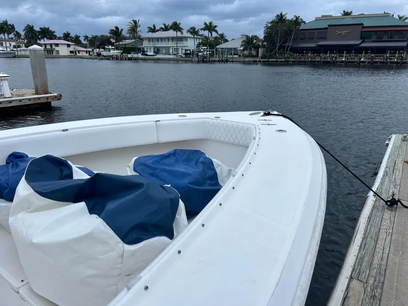 Slide: The Image of 2004 Venture 34 Center Console boat docked by waterfront homes. - 5
