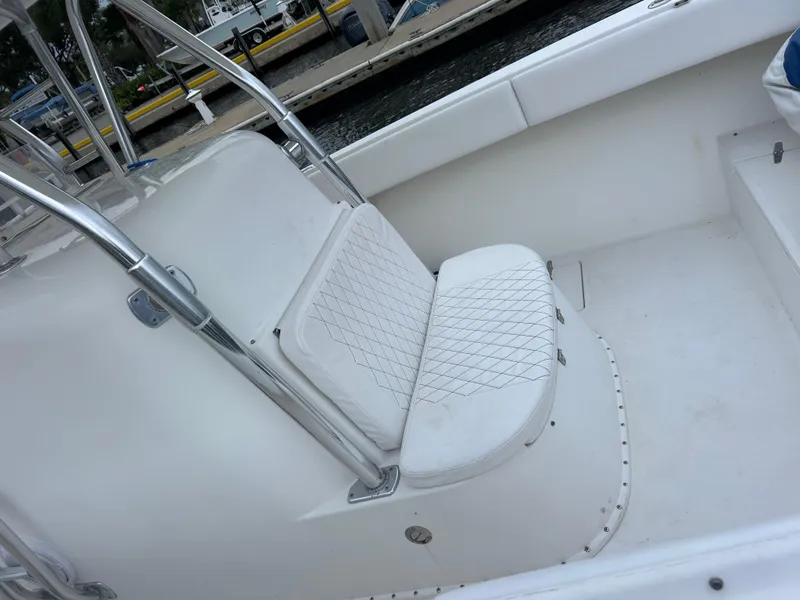 Slide: The Image of 2004 Venture 34 Center Console boat interior with white cushioned seating. - 6