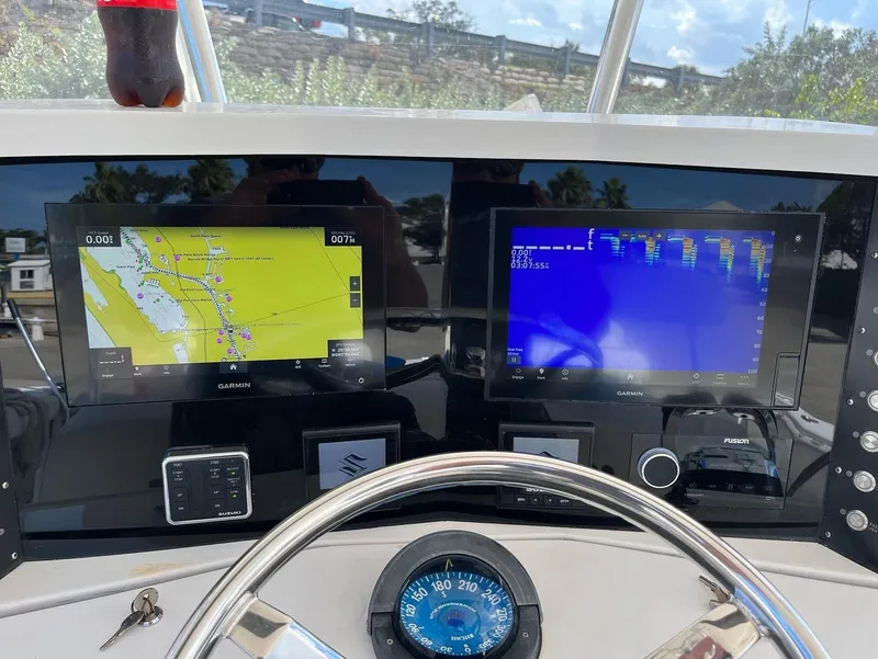 Slide: The Image of 2004 Venture 34 Center Console dashboard with navigation and sonar displays. - 8