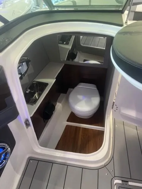 Slide: The Image of Interior of 2024 Chaparral 26 Surf featuring toilet and sink. - 10