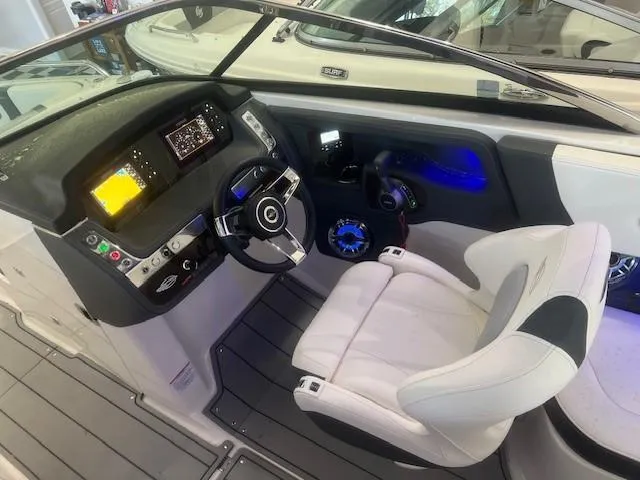 Slide: The Image of Interior of 2024 Chaparral 26 Surf with modern cockpit and controls. - 11