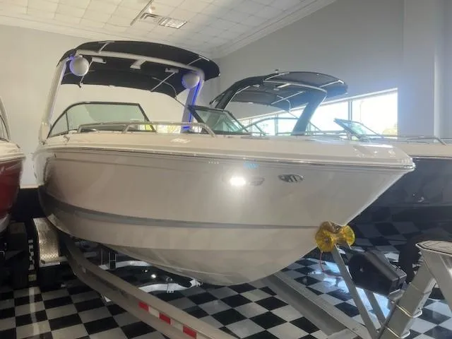 Slide: The Image of 2024 Chaparral 26 Surf boat in showroom on trailer. - 2