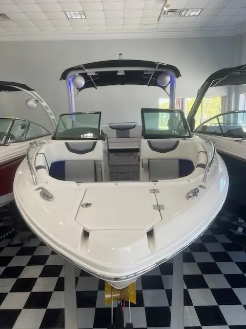 Slide: The Image of 2024 Chaparral 26 Surf boat in showroom, front view. - 3