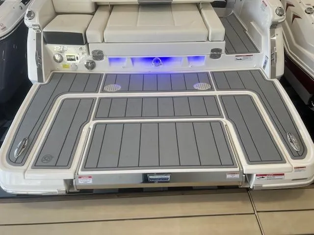 Slide: The Image of 2024 Chaparral 26 Surf swim platform with gray decking and blue lighting. - 4
