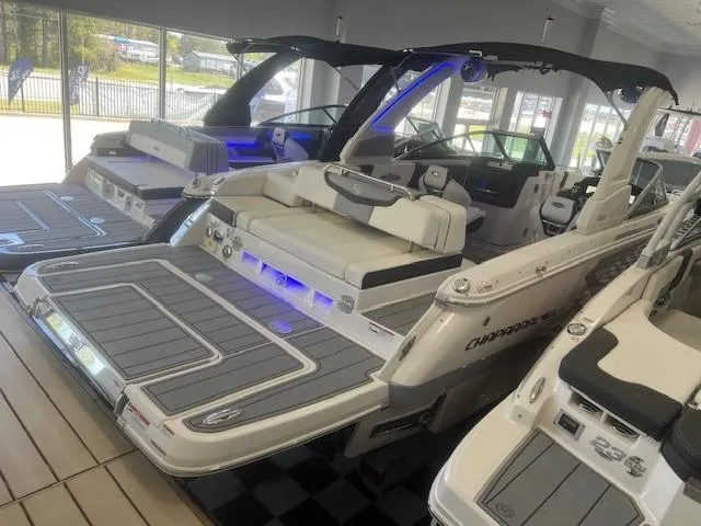 Slide: The Image of 2024 Chaparral 26 Surf boat displayed in showroom. - 5