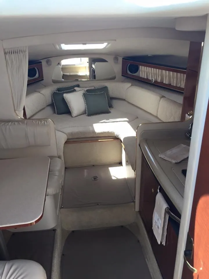 Slide: The Image of 2001 Sea Ray 280 Sundancer cabin interior with seating, table, and kitchenette. - 11