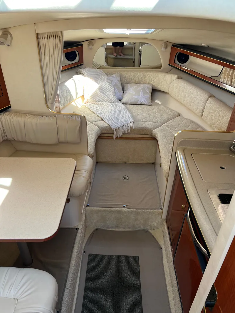 Slide: The Image of Interior of 2001 Sea Ray 280 Sundancer, featuring cozy seating and elegant design. - 17