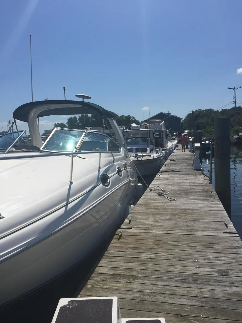 Slide: The Image of 2001 Sea Ray 280 Sundancer docked under clear blue sky. - 2