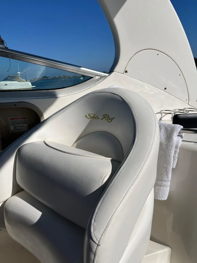 Slide: The Image of 2001 Sea Ray 280 Sundancer boat interior with white seating and clear blue sky. - 20