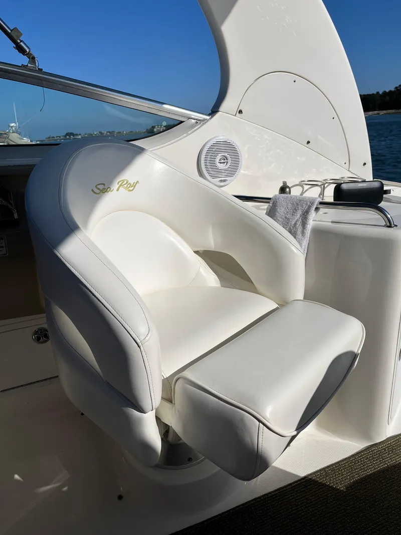 Slide: The Image of 2001 Sea Ray 280 Sundancer cockpit with white leather seat and ocean view. - 21