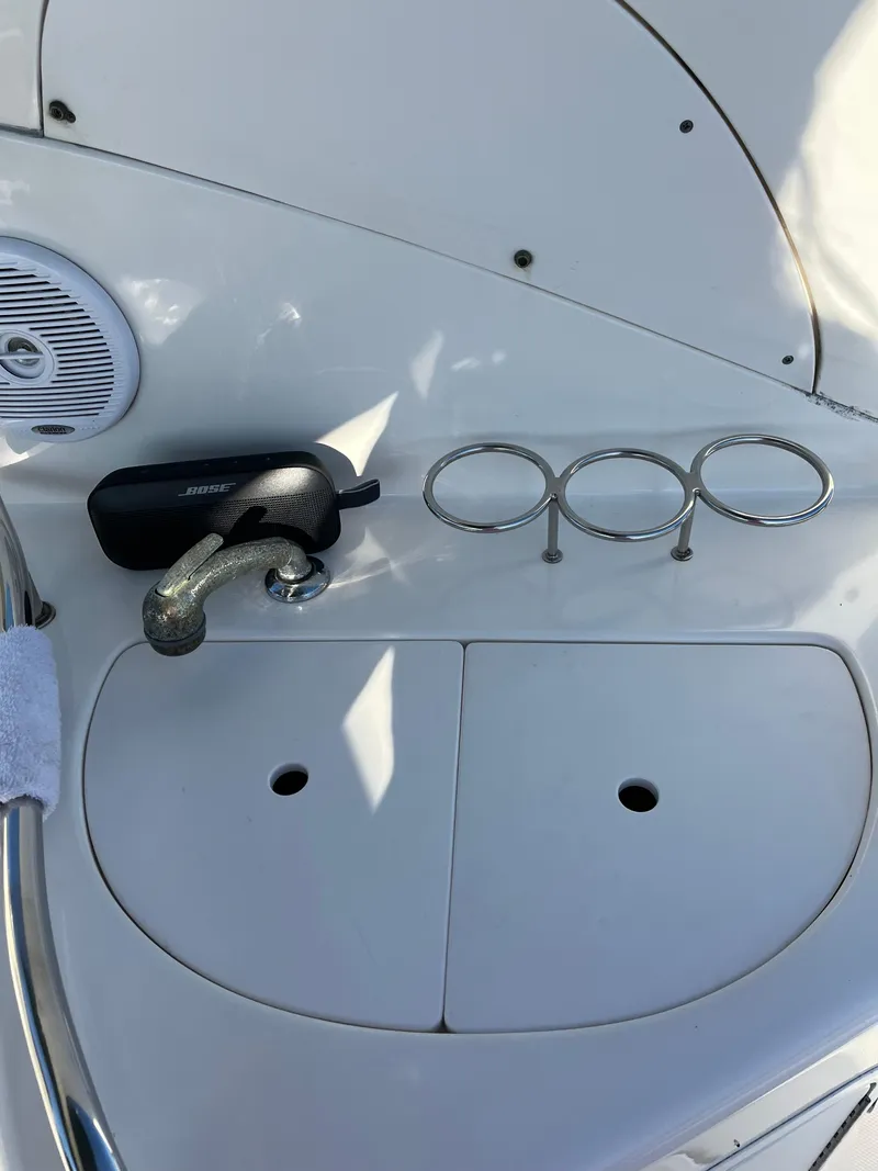 Slide: The Image of 2001 Sea Ray 280 Sundancer deck with speaker, faucet, and cup holders. - 24