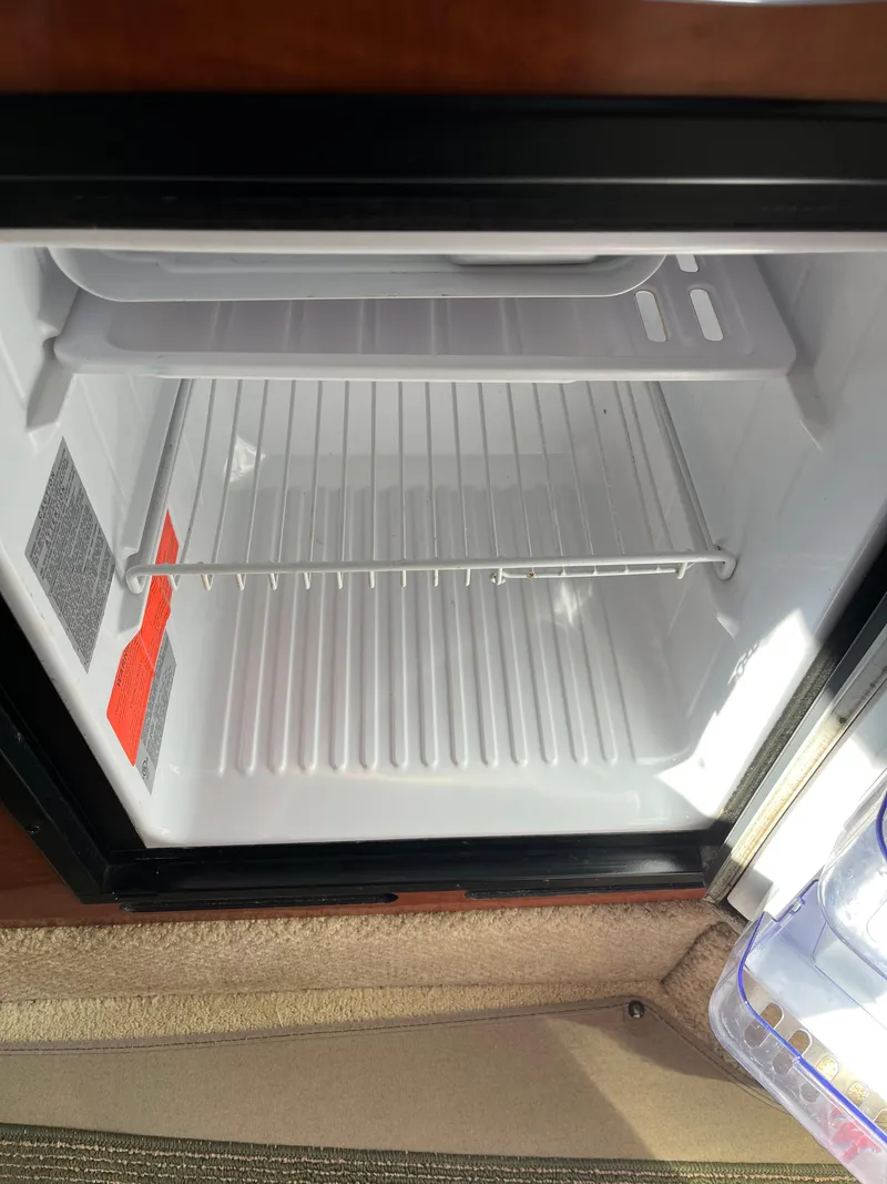 Slide: The Image of Empty refrigerator inside 2001 Sea Ray 280 Sundancer boat. - 25