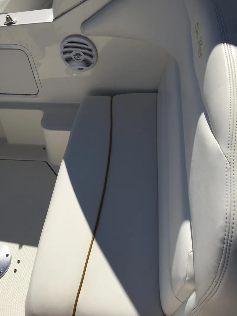 Slide: The Image of 2001 Sea Ray 280 Sundancer boat interior with white seating and speaker. - 29