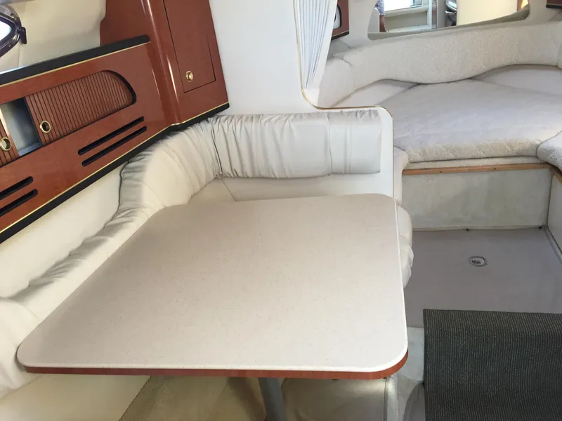 Slide: The Image of Interior of 2001 Sea Ray 280 Sundancer with dining area and seating. - 32