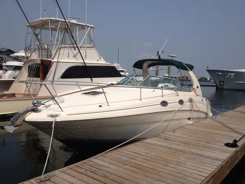 Slide: The Image of 2001 Sea Ray 280 Sundancer docked at marina, clear day, other boats visible. - 34