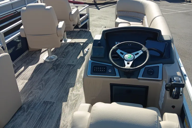 Slide: The Image of 2024 Ranger Reata 220FC boat interior with steering console and seating. - 3