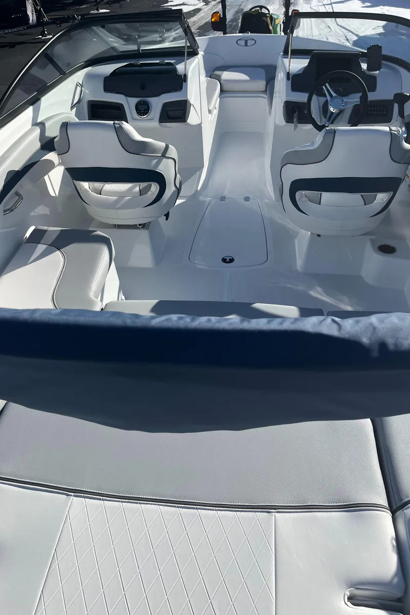Slide: The Image of 2024 Tahoe 210 Si boat interior with white and blue seating. - 1
