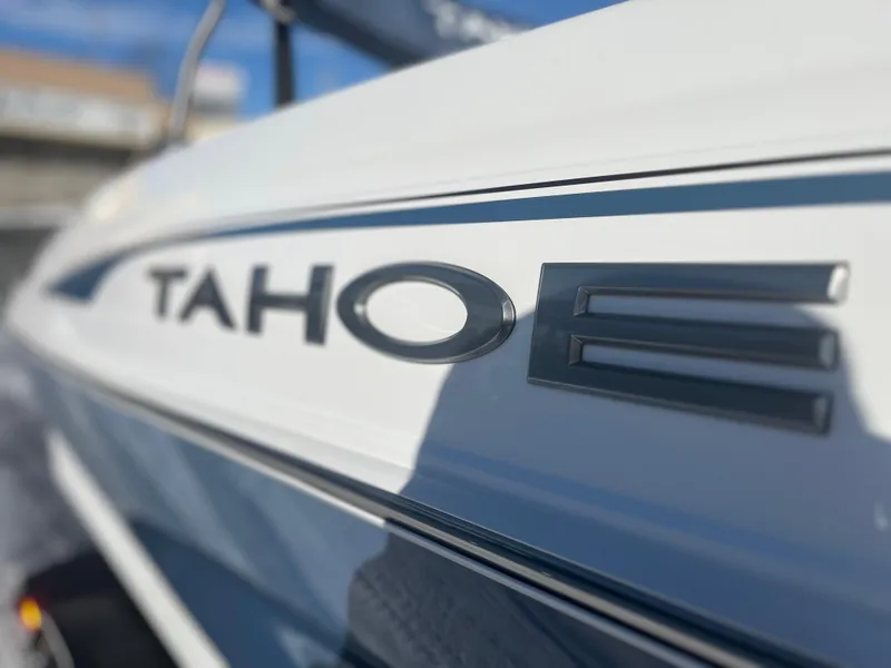 Slide: The Image of 2024 Tahoe 210 Si boat close-up, showcasing sleek design and branding. - 2