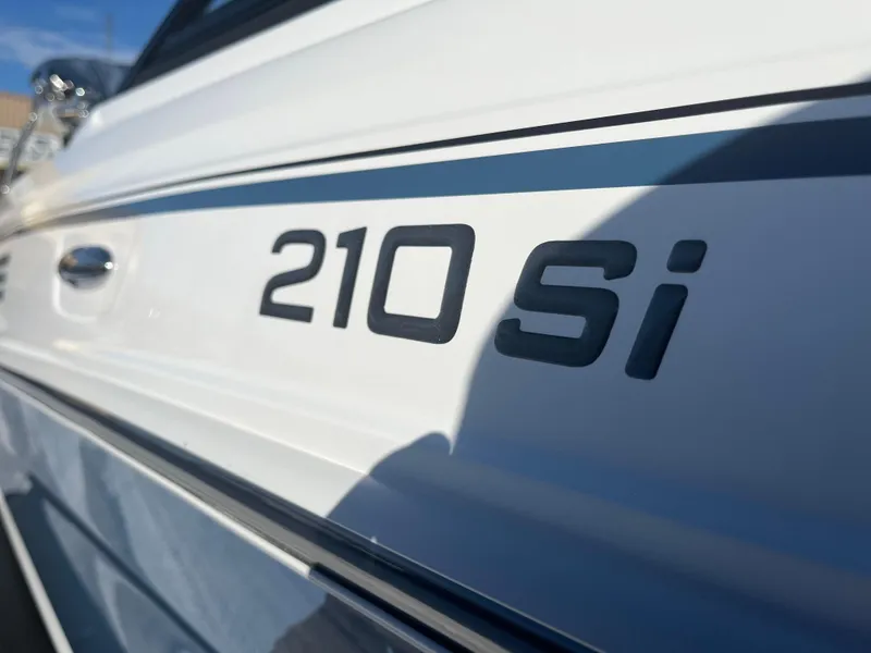 Slide: The Image of Close-up of 2024 Tahoe 210 Si boat model name on white hull. - 4