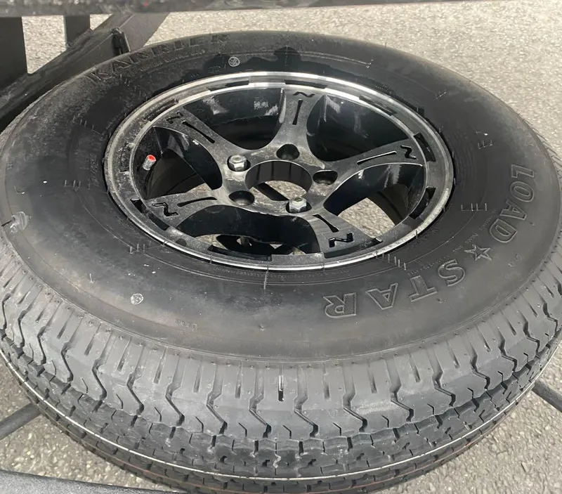 Slide: The Image of 2024 Nitro Z21 XL Pro spare tire with Load Star branding. - 14