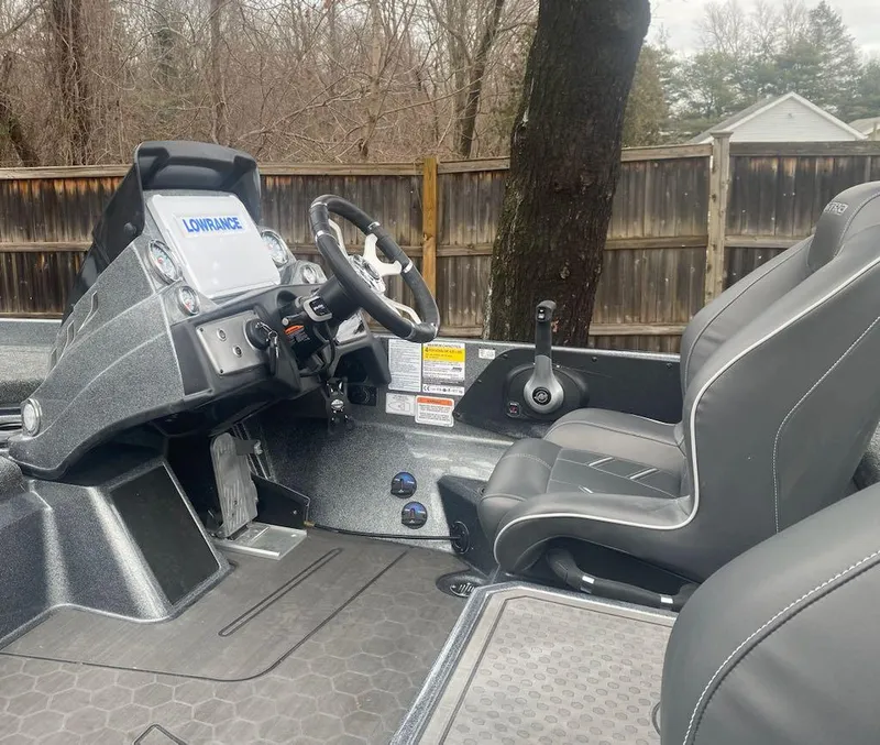 Slide: The Image of 2024 Nitro Z21 XL Pro boat interior with steering console and seats. - 17