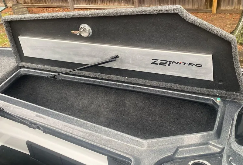Slide: The Image of 2024 Nitro Z21 XL Pro boat storage compartment with open lid. - 19