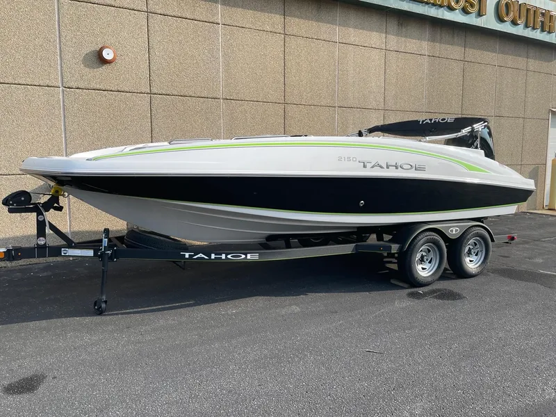 The Image of 2024 Tahoe 2150 boat on trailer, sleek design, parked outdoors. - 0