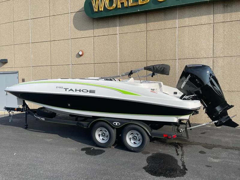 Slide: The Image of 2024 Tahoe 2150 boat on trailer, parked outdoors, side view. - 1