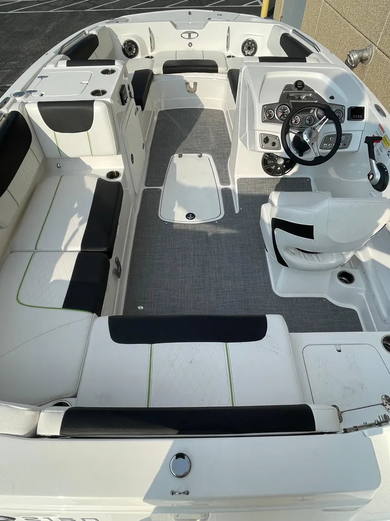 Slide: The Image of 2024 Tahoe 2150 boat interior with seating and steering console. - 2