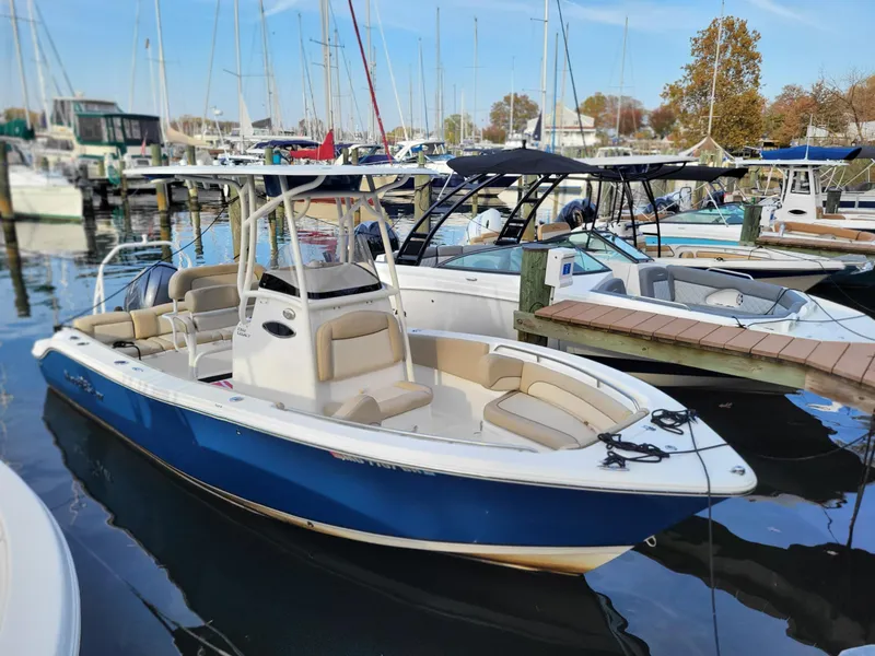 Slide: The Image of 2021 NauticStar 2302 Legacy boat docked in a marina with other boats. - 9