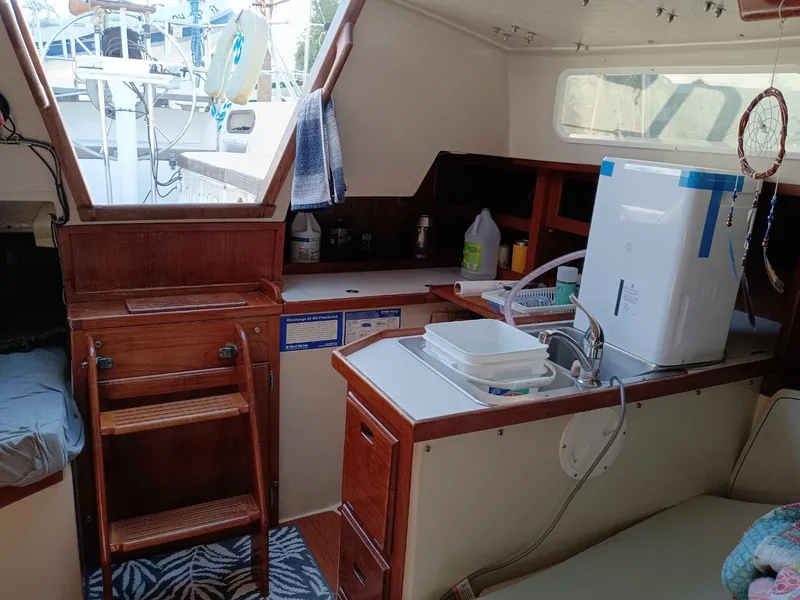 Slide: The Image of Interior of 1985 Catalina 38 sailboat with kitchenette and wooden cabinetry. - 11