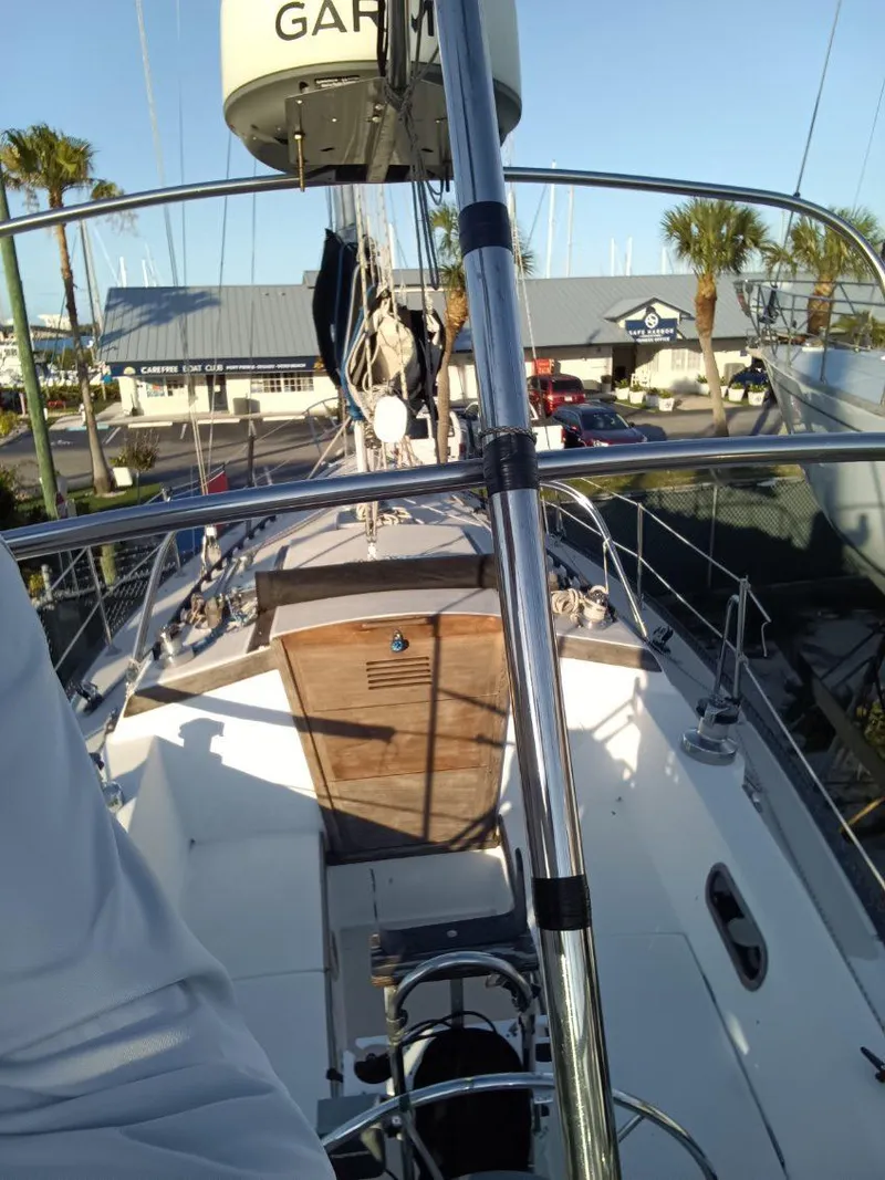Slide: The Image of 1985 Catalina 38 sailboat deck with marina backdrop and palm trees. - 14