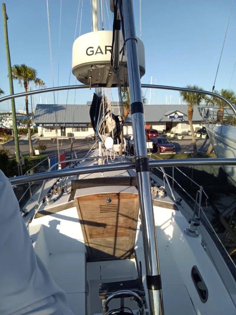 Slide: The Image of 1985 Catalina 38 sailboat deck view with marina background and clear sky. - 15
