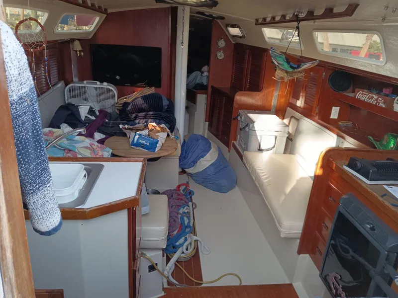 Slide: The Image of Interior of a 1985 Catalina 38 sailboat with cluttered living space. - 3