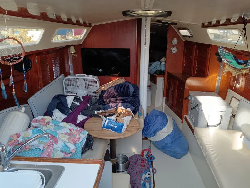 Slide: The Image of Interior of 1985 Catalina 38 sailboat with cozy seating and nautical decor. - 4